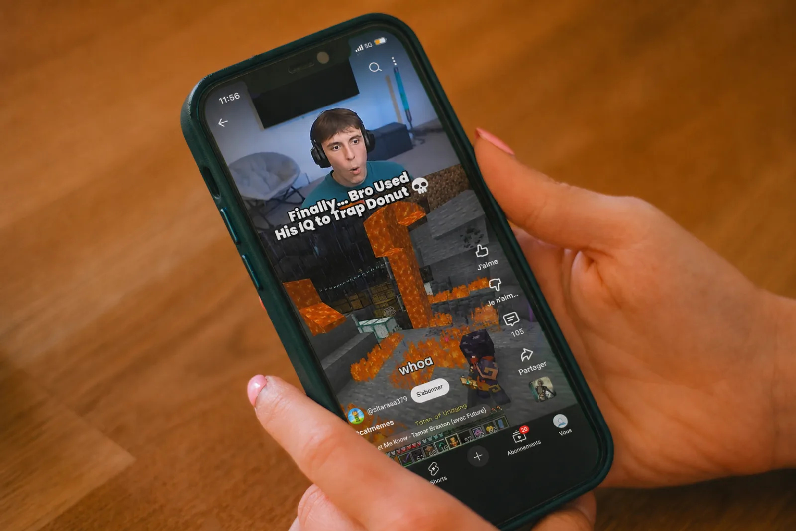 A hand holding an iPhone displaying YouTube Shorts playing a vertical video — the feed Nope hides.